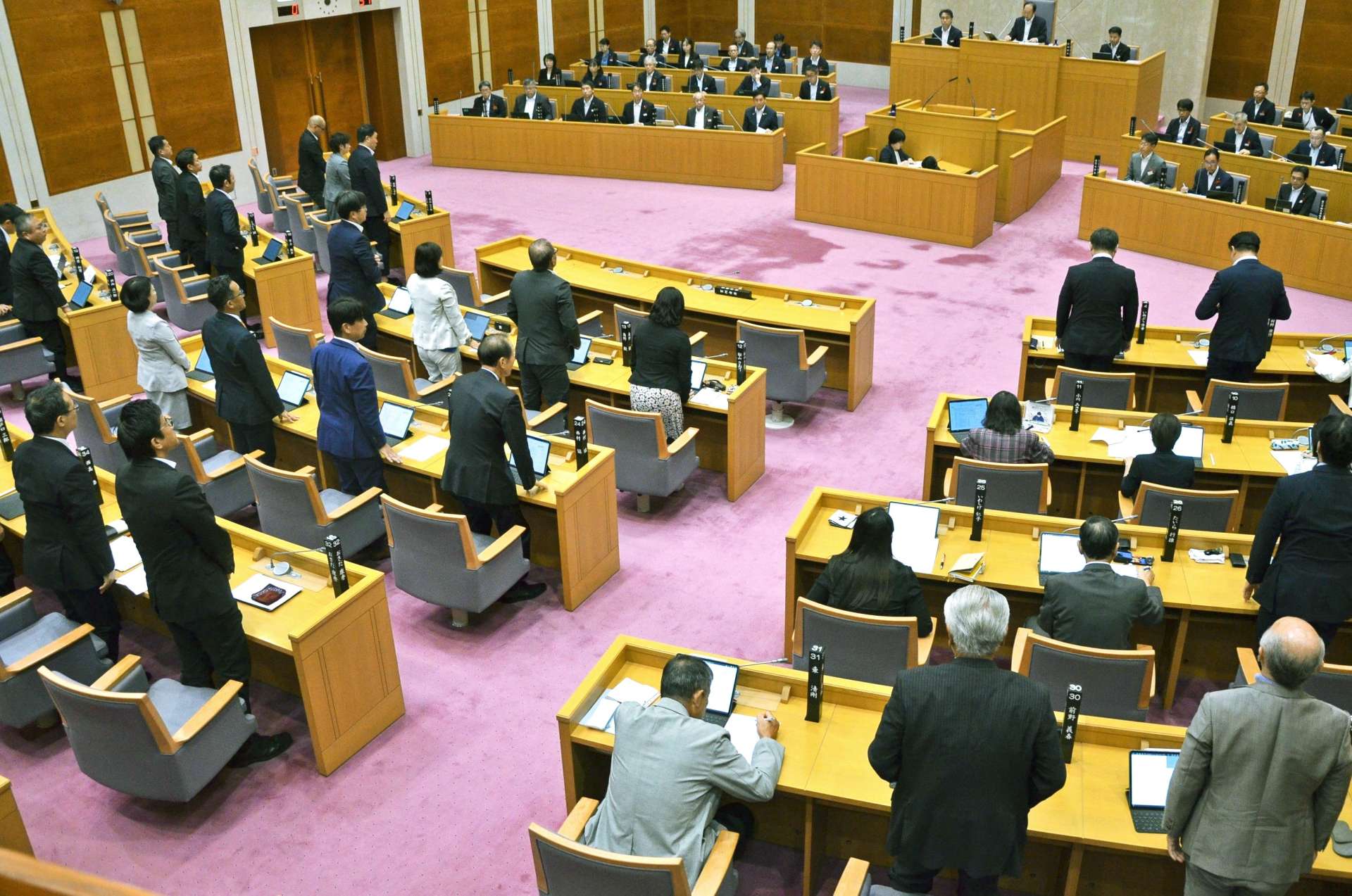 新総合体育館の約９億円に上る設計関連費用の撤回を求める陳情の採決に臨む議員ら＝２日、県議会