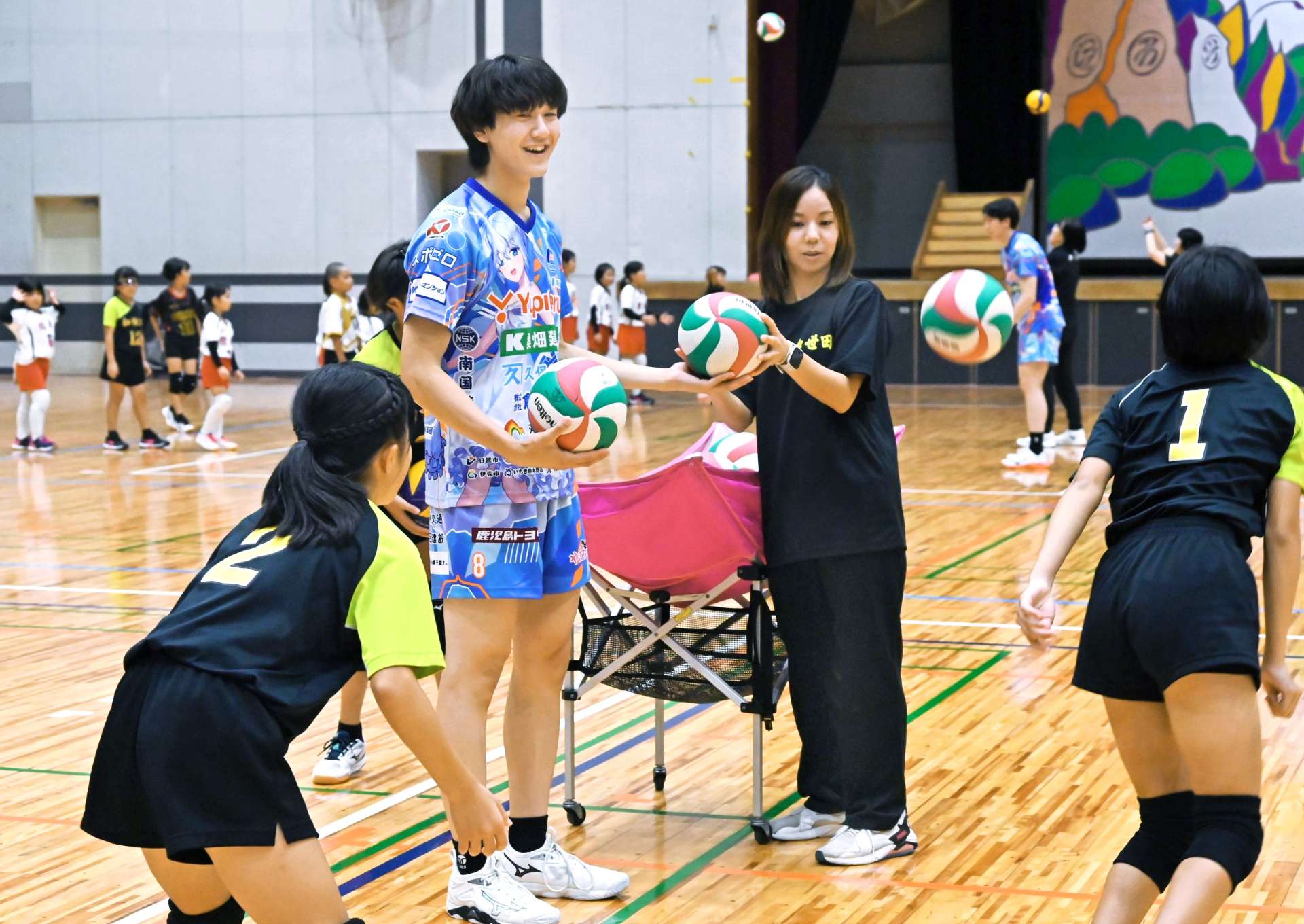子どもたちにバレーボールを指導する原亜久里選手＝南さつま市加世田武田