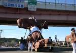 〈関連＝まるでイナバウアー〉体を傾け、高架橋をくぐる大隅弥五郎どん＝曽於市大隅町岩川