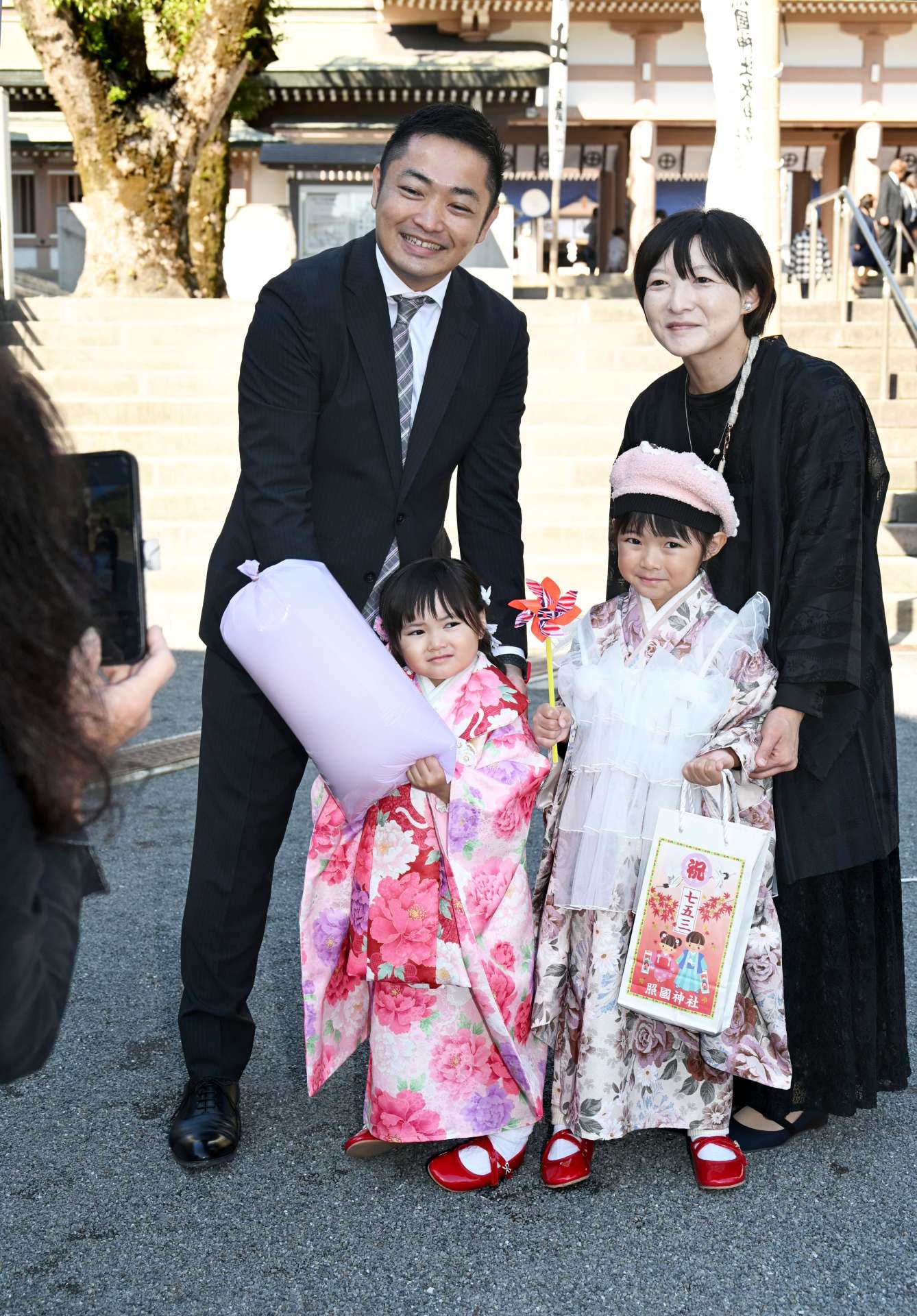 七五三参りで記念撮影する家族連れ＝１５日、鹿児島市の照国神社